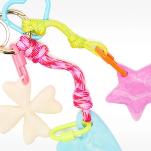Colorful resin heart and star bag charms with vibrant braided nylon ropes and metal rings