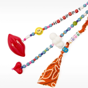 Detail of bohemian bag charm with colorful beads, HAPPY and LOVE charms and orange tassel