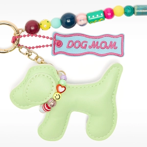 Detail of green leather dog charm with Dog Mom embroidery and colorful beads