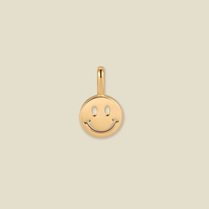 Close-up of polished gold smiling face pendant featuring a hollow minimalist design