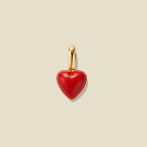 Macro view of a 3D red heart pendant with polished gold bail for necklaces