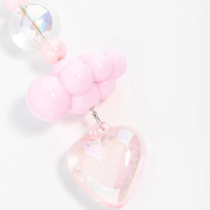 Detail view of pink resin bag charm featuring glitter heart and cloud shaped beads