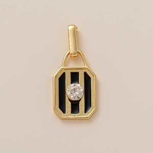 Detail of 18K gold-plated rectangular charm with black stripes and white zircon stone