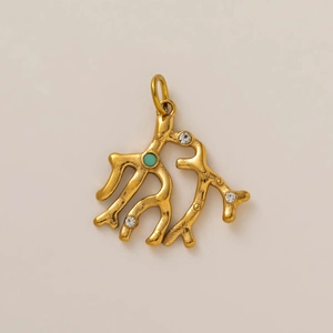 Detail of coral shaped 18K gold pendant featuring a green gemstone and white crystals