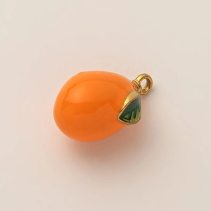 Dettaglio ravvicinato del ciondolo a forma di frutto placcato oro 18K con smalto arancione