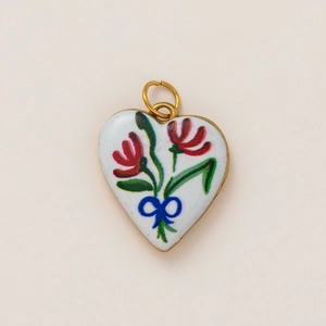 Detailed close-up of a heart pendant with 18K gold plating and enamel floral pattern