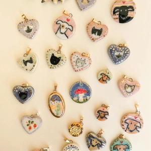 Handcrafted ceramic heart pendants with 18K gold plated hooks and hand-painted animal motifs