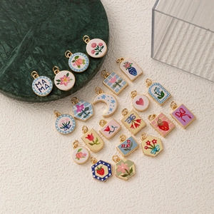 Minimalist enamel floral and heart charms in assorted shapes with gold plated edges