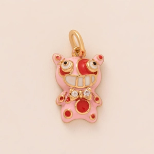 Pink enamel clownfish pendant charm with red spots and a gold bow tie decoration