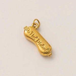 Close-up of golden moon-shaped pendant engraved with Do Not Disturb text and 18K gold finish