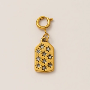 Detailed close-up of 18K gold plated pendant with sparkling white rhinestones stars