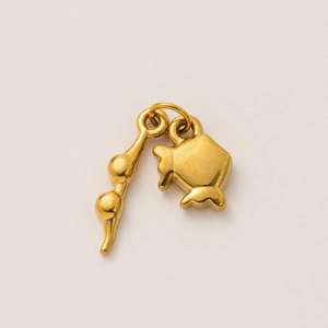 Macro detail of a 18K gold plated moon wine glass pendant with matte metal texture