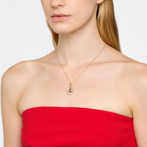 Golden horseshoe necklace with Saturn logo and crystal inlay worn by female model