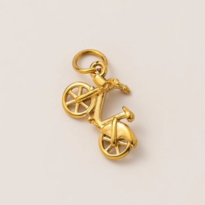 Macro view of detailed 18K gold plated stainless steel bicycle pendant with hanging loop