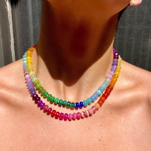 Detail of layered colorful beaded necklace with translucent gemstone beads on a model