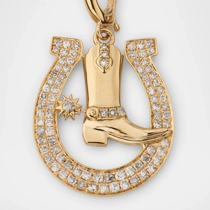 Macro view of 18k gold plated cowboy boot and horseshoe pendant with sparkling crystals