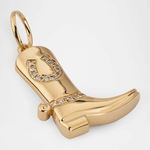 Detailed macro shot of a gold cowboy boot pendant with horseshoe stone inlay
