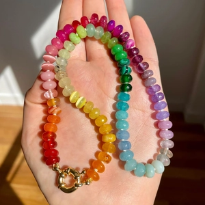 Detail of colorful gemstone beaded necklace with golden spring ring clasp closure