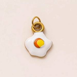 Detailed view of creative fried egg enamel pendant with 18K gold plated metal rings