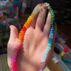 Vibrant rainbow beaded necklace with translucent colorful beads and silver metal clasp