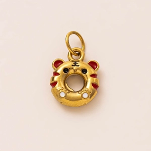 Macro detail of tiger head donut pendant with 18K gold plating and enamel inlay