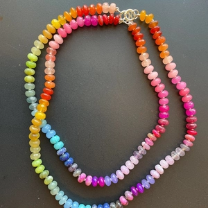 Macro detail of faceted rainbow beads on stainless steel necklace with silver clasp