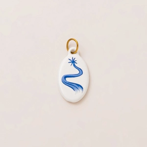 Minimalist white oval pendant with navy blue star pattern and gold hanging ring