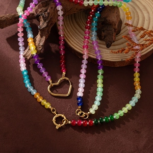 Colorful beaded necklace featuring a hollow gold heart pendant and large spring clasp
