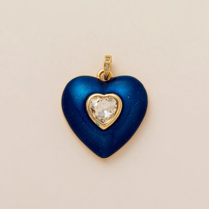 Vue détaillée du pendentif cœur en émail bleu roi, paillettes et bordure dorée