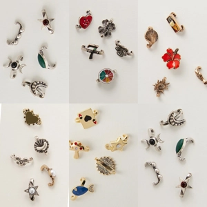 Macro detail of retro DIY flip-flop charms including poker card and star metal pendants
