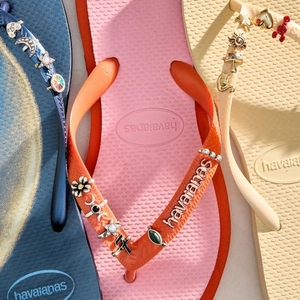 Havaianas flip flops with colorful DIY charms including stars, moon, and lobster pendants