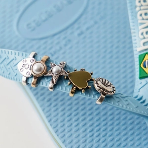 DIY shoe charms set featuring vintage silver heart lock and pearl star on blue flip flops