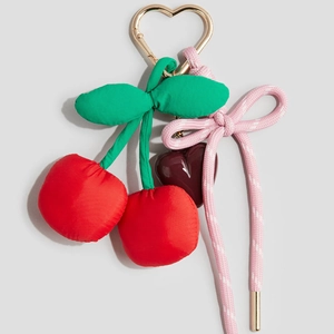 Red cherry keychain pendant with gold heart clasp and pink braided knot charm accessory