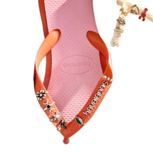 Pink and orange flip flops with DIY poker and bohemian charms on colorful straps