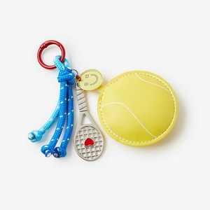 Detail of yellow tennis ball coin purse keychain with silver racket and blue woven rope