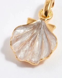 Macro shot of gold-plated shell pendant with pink pearlescent enamel finish details
