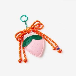 Close-up of pink leather strawberry keychain with orange bow and green metal clip