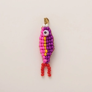 Close-up of handmade colorful beaded fish keychain with a gold metal lobster clasp