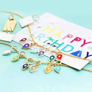 Colorful enamel teardrop necklaces and Brasil charms on a birthday gift card