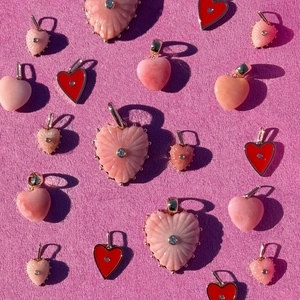 Assorted heart pendants with pink floral textures and red enamel designs for DIY necklaces