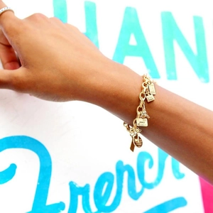 French vintage style gold alloy charm bracelet featuring Eiffel Tower and perfume charms