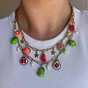 Double-layered gold chain necklace with colorful resin fruit charms and pearl details