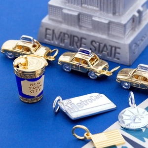 Detailed New York City themed charms featuring taxi, coffee cup, and metro card
