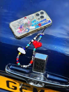 Colorful beaded phone strap with heart and cloud charms on a decorative clear case