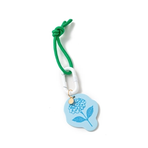 Detailed view of woven green cord with blue hydrangea tag and white carabiner hook