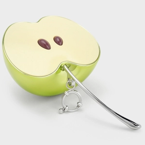 Detalle del colgante de manzana verde con acabado metálico brillante y cierre