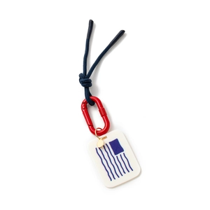 Close-up of blue braided rope keychain with red carabiner and abstract graphic pendant