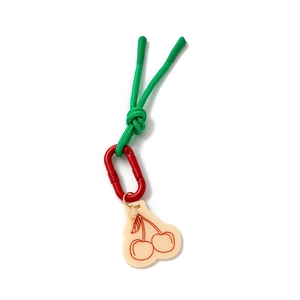 Detail of keychain with green nylon rope, red carabiner, and cream cherry pendant charm
