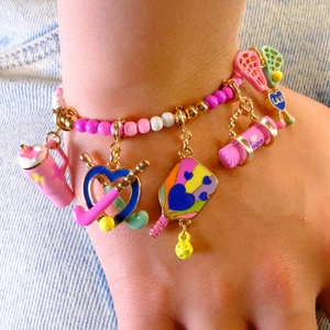 Colorful beaded bracelet with pink sports charms like pickleball paddle and yoga mat