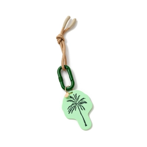 Detail of keychain featuring a palm tree pendant with a green clip and woven sand rope